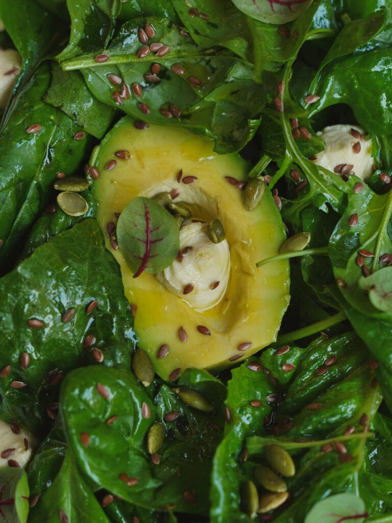Magnesium rich foods including spinach, almonds, avocado, pumpkin seeds, and dark chocolate