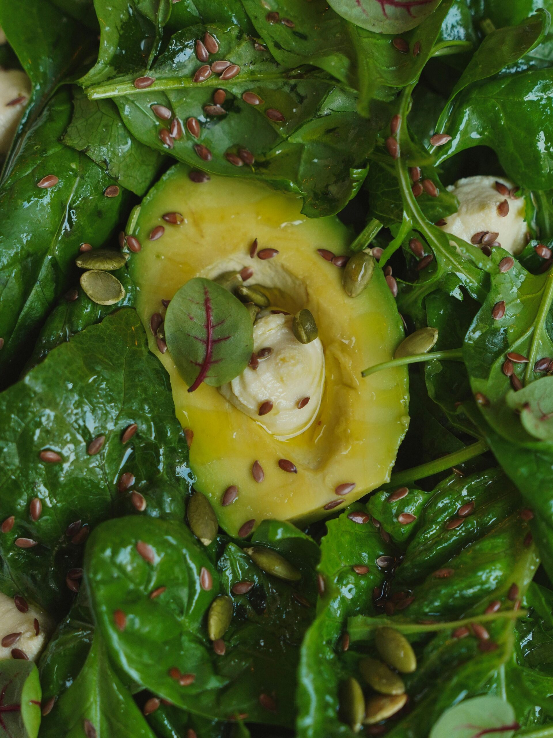 Magnesium rich foods including spinach, almonds, avocado, pumpkin seeds, and dark chocolate